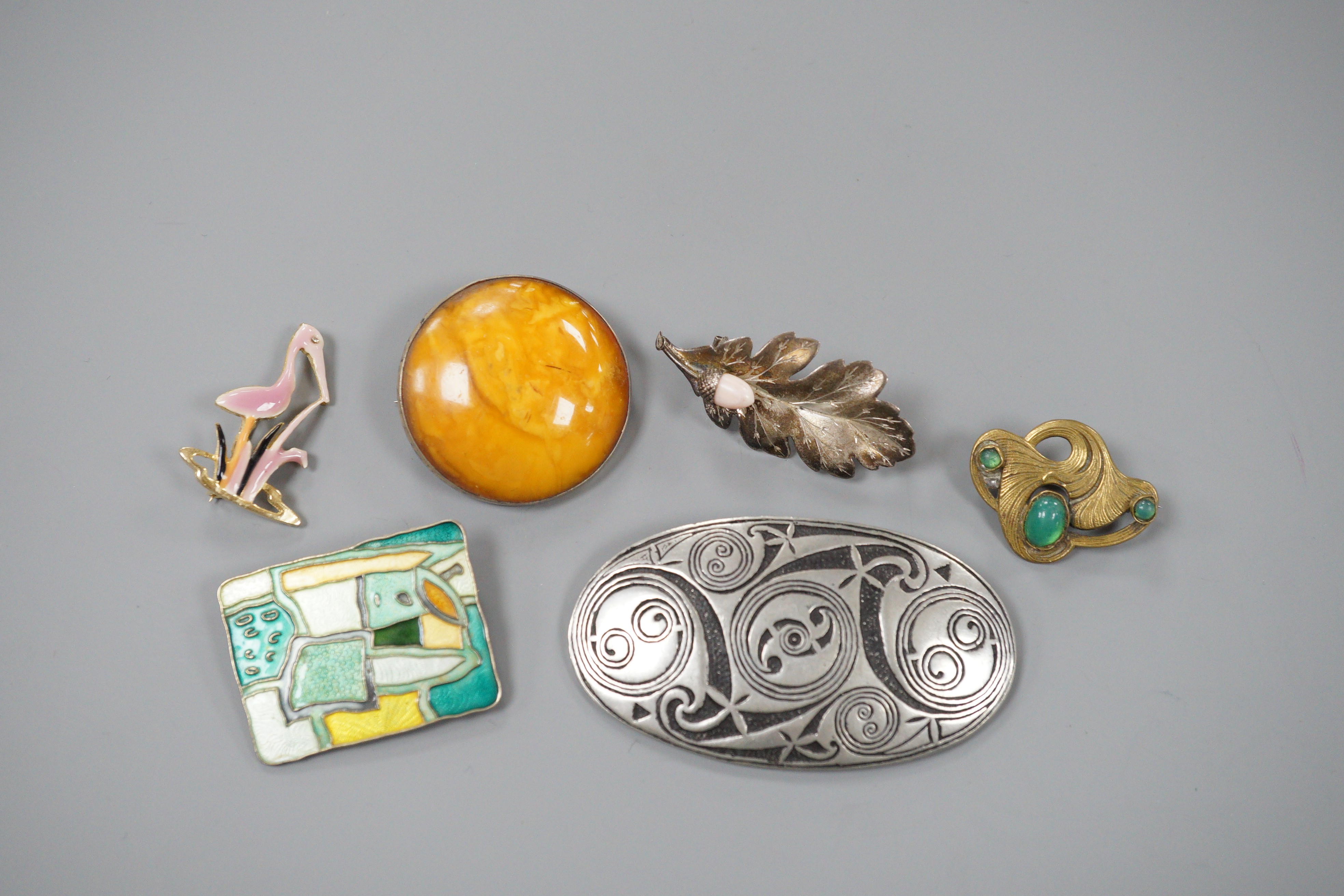 A Norwegian sterling and polychrome enamel set modernist brooch by David Andersen, 43mm and five other brooches including amber.